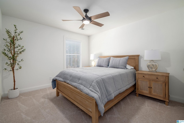 bedroom with light colored carpet and ceiling fan