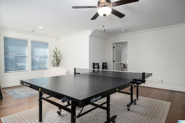 playroom with ceiling fan, ornamental molding, and hardwood / wood-style flooring