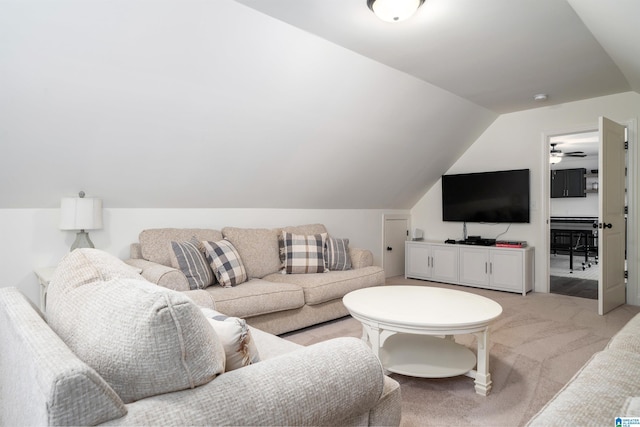 carpeted living room featuring ceiling fan and lofted ceiling