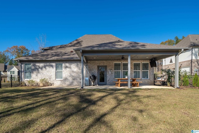 back of property featuring a patio, ceiling fan, and a lawn