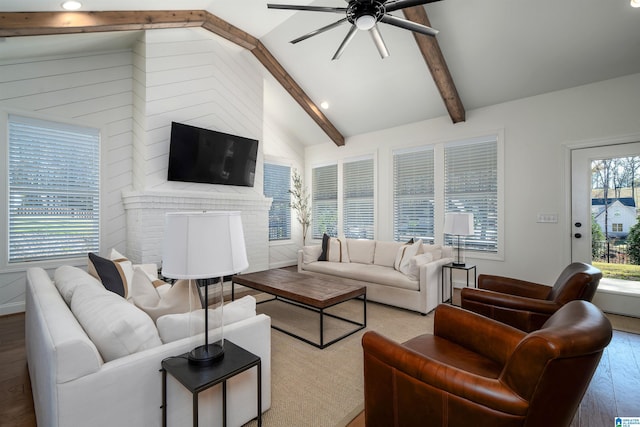 living room featuring a fireplace, vaulted ceiling with beams, hardwood / wood-style flooring, and ceiling fan