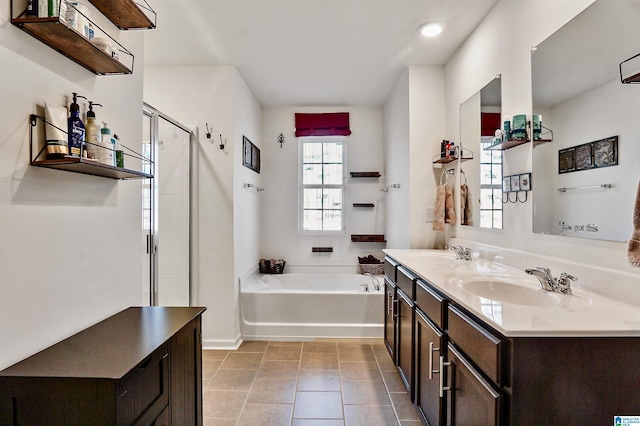 bathroom with tile patterned flooring, vanity, and independent shower and bath