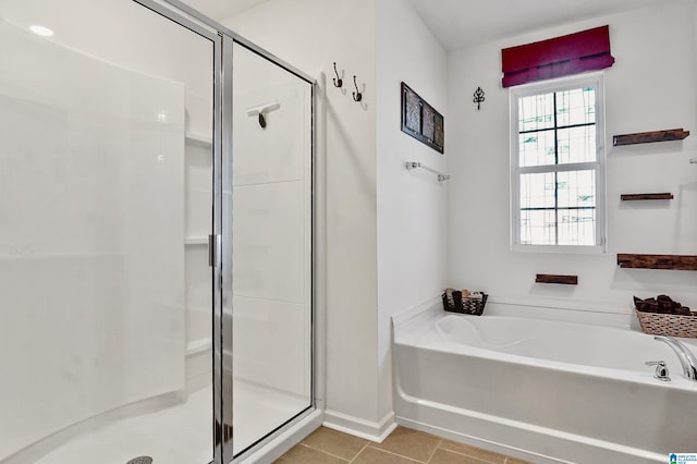 bathroom featuring tile patterned flooring and separate shower and tub