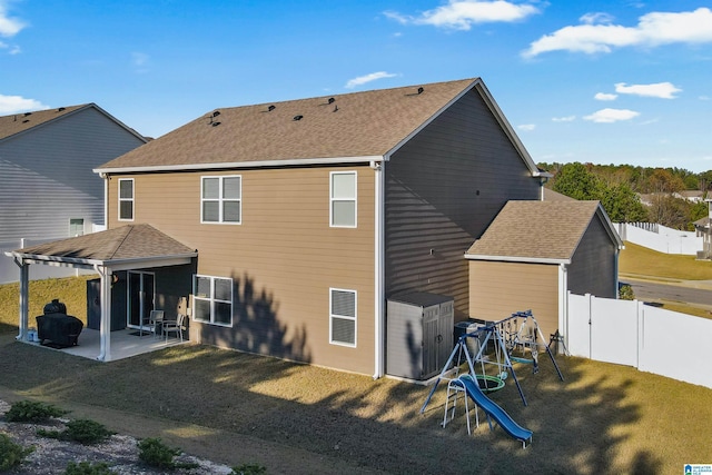 back of property featuring a patio area and a yard