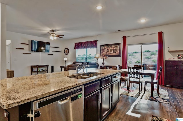 kitchen featuring ceiling fan, dishwasher, sink, dark hardwood / wood-style floors, and a center island with sink