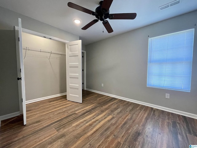 1304 3rd St SE, Cullman, AL 35055 - unfurnished bedroom featuring multiple windows, dark hardwood / wood-style flooring, a closet, and ceiling fan