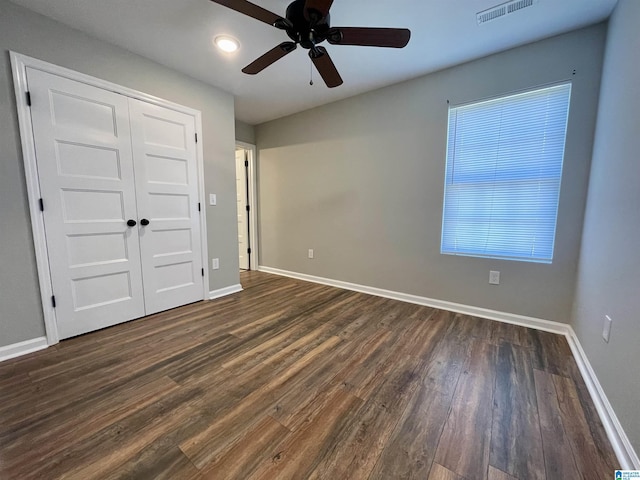 1314 3rd St, Cullman, AL 35055 - unfurnished bedroom with a closet, ceiling fan, and dark wood-type flooring