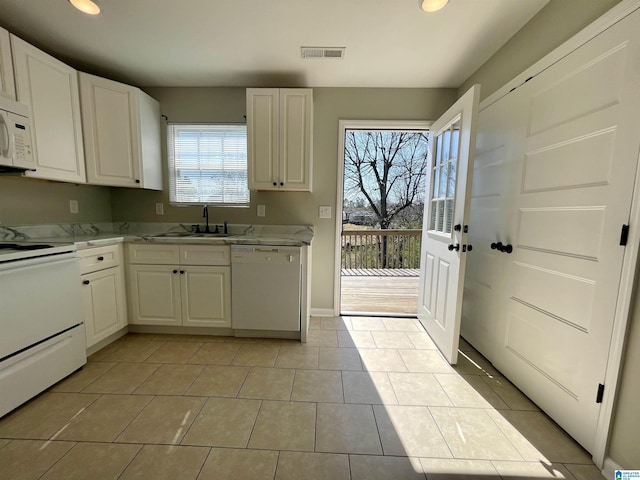 1314 3rd St, Cullman, AL 35055 - kitchen with white cabinetry, sink, a healthy amount of sunlight, and white appliances