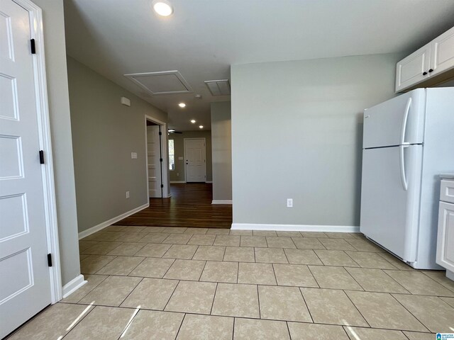 1314 3rd St, Cullman, AL 35055 - kitchen with white cabinets, white refrigerator, and light wood-type flooring