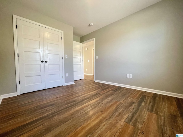 1314 3rd St, Cullman, AL 35055 - unfurnished bedroom featuring dark wood-type flooring and a closet