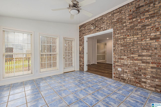 spare room featuring ceiling fan, brick wall, vaulted ceiling, and hardwood / wood-style flooring