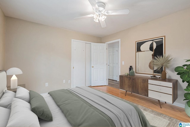 bedroom featuring hardwood / wood-style floors, ceiling fan, and a closet