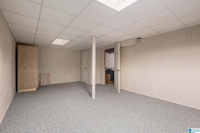 basement with carpet flooring and a drop ceiling