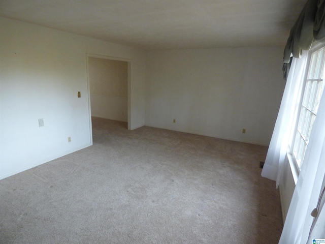 unfurnished room with a healthy amount of sunlight and light colored carpet