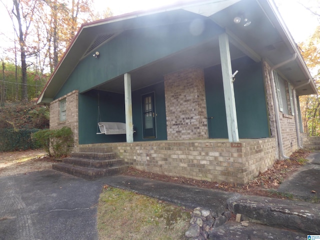 view of side of home featuring a porch