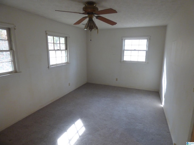 empty room featuring light carpet and ceiling fan