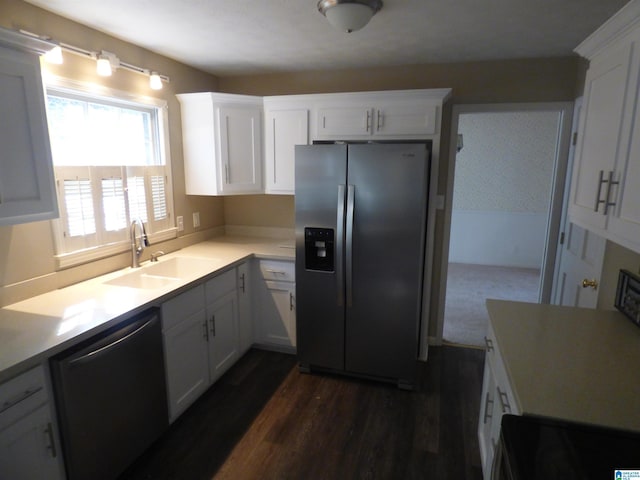 kitchen featuring appliances with stainless steel finishes, white cabinetry, and sink