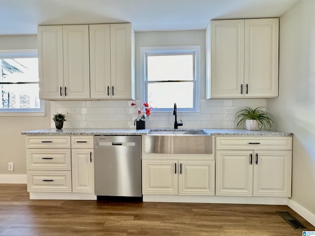 kitchen featuring a healthy amount of sunlight, dark hardwood / wood-style flooring, and stainless steel dishwasher