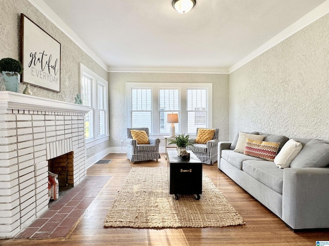 living room with a fireplace, hardwood / wood-style flooring, and crown molding