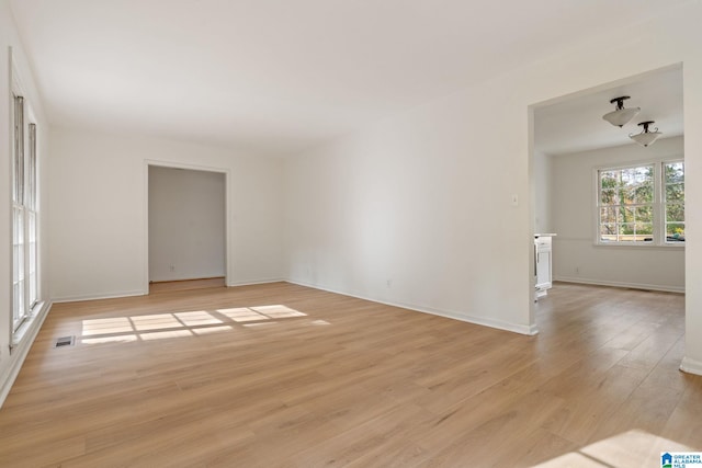 empty room with light hardwood / wood-style flooring