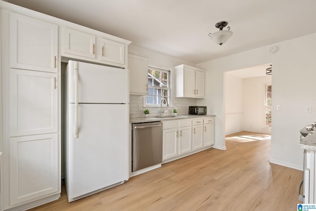 kitchen with dishwasher, white cabinets, sink, light hardwood / wood-style floors, and white fridge