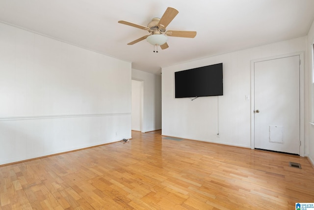 empty room with light hardwood / wood-style flooring and ceiling fan