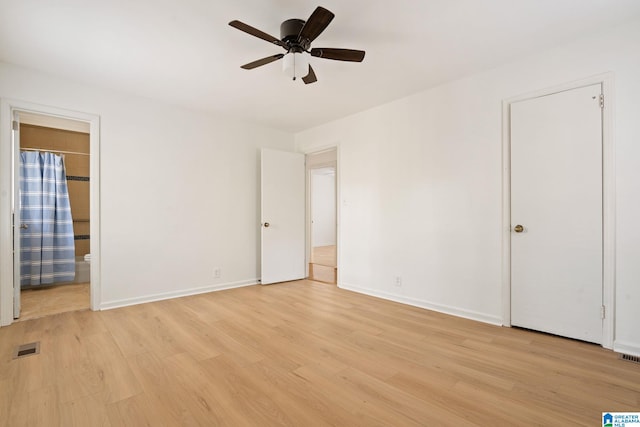 unfurnished bedroom with ensuite bath, ceiling fan, and light hardwood / wood-style floors