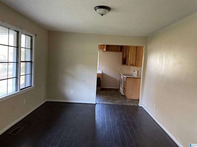 unfurnished dining area with dark hardwood / wood-style flooring