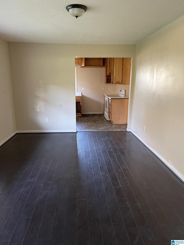 unfurnished living room featuring dark hardwood / wood-style flooring and a textured ceiling