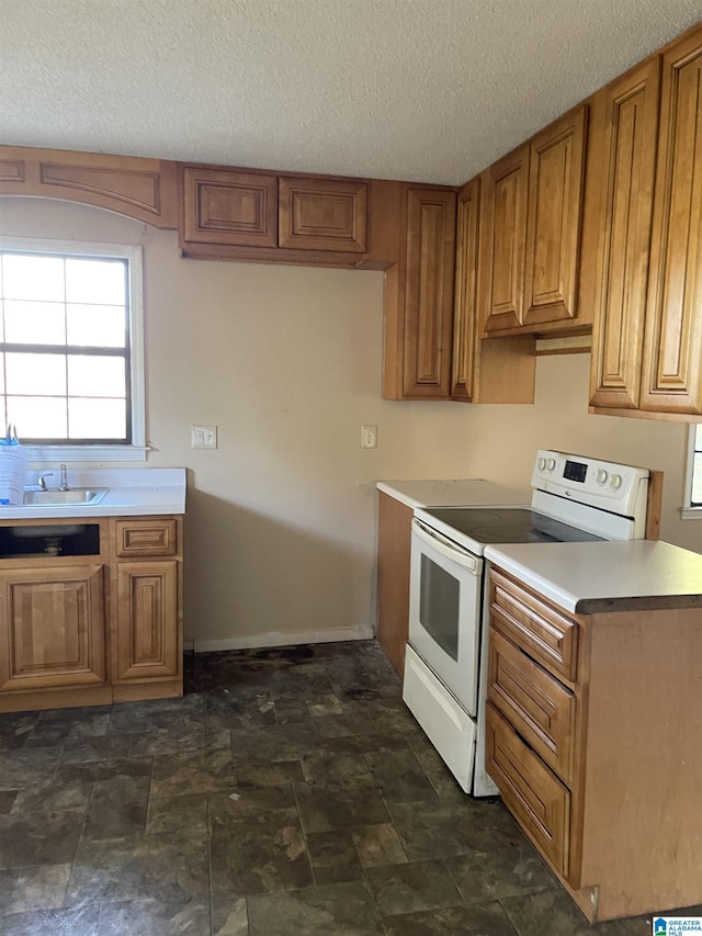 kitchen with a textured ceiling, white electric range, and sink