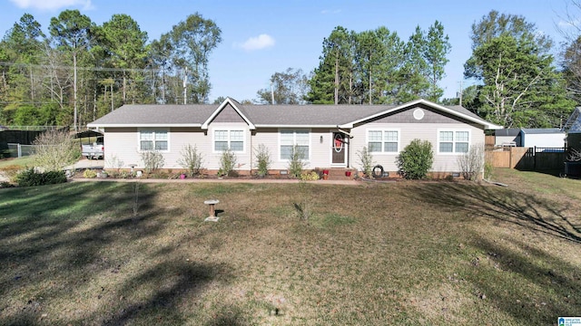 ranch-style house featuring a front lawn and a carport