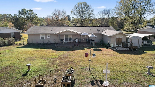 back of property with a yard, a deck, and a storage shed