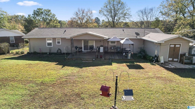 view of front of house featuring a front lawn and a wooden deck