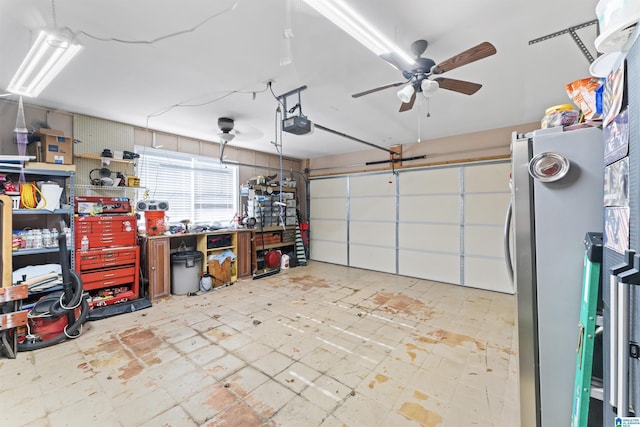 garage with stainless steel refrigerator, a workshop area, ceiling fan, and a garage door opener