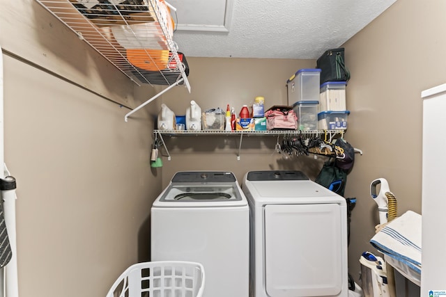 clothes washing area featuring washer and dryer and a textured ceiling