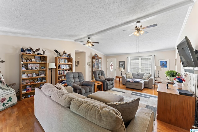 living room with wood-type flooring, a textured ceiling, ceiling fan, and crown molding