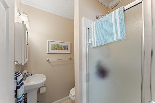 bathroom featuring crown molding, a shower with shower door, and toilet