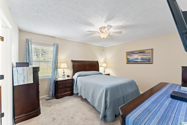 carpeted bedroom with a textured ceiling and ceiling fan