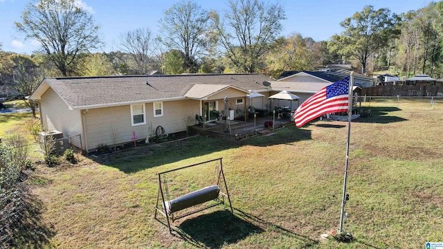 rear view of property featuring a yard