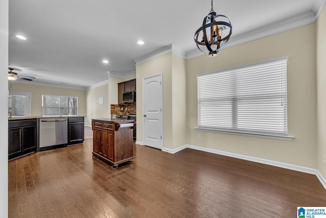 kitchen featuring dark brown cabinets, stainless steel appliances, crown molding, dark hardwood / wood-style floors, and a kitchen island