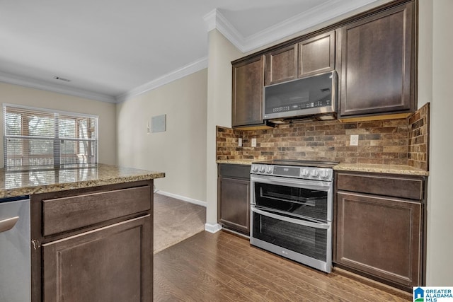 kitchen with dark brown cabinetry, stainless steel appliances, dark hardwood / wood-style flooring, backsplash, and ornamental molding