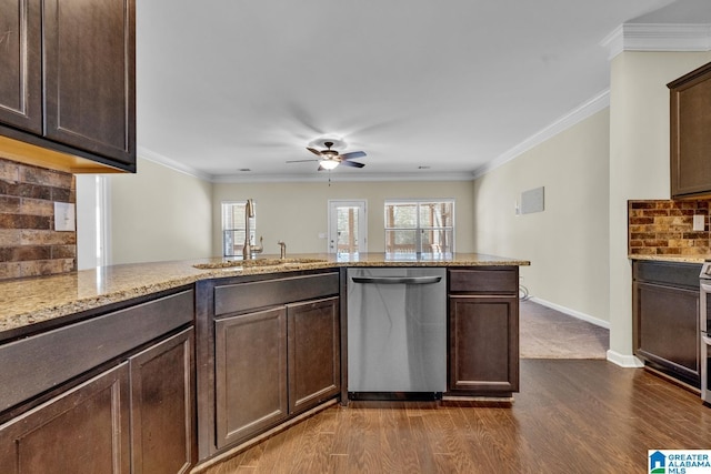 kitchen featuring dark wood-type flooring, crown molding, sink, stainless steel dishwasher, and dark brown cabinets