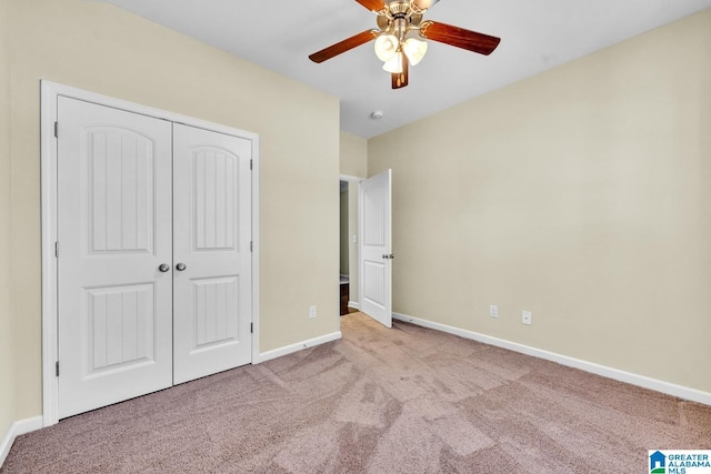 unfurnished bedroom featuring ceiling fan, light carpet, and a closet