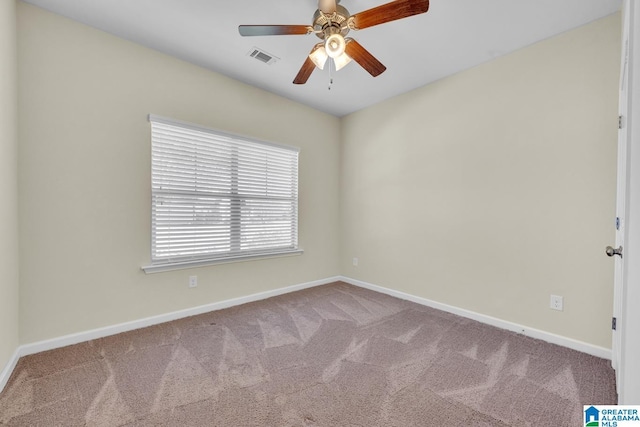 empty room featuring ceiling fan and light colored carpet