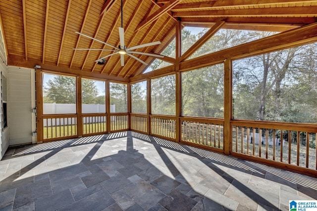 unfurnished sunroom featuring vaulted ceiling with beams, ceiling fan, and wood ceiling