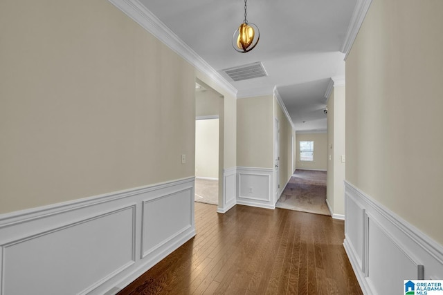 hall with dark hardwood / wood-style floors and crown molding