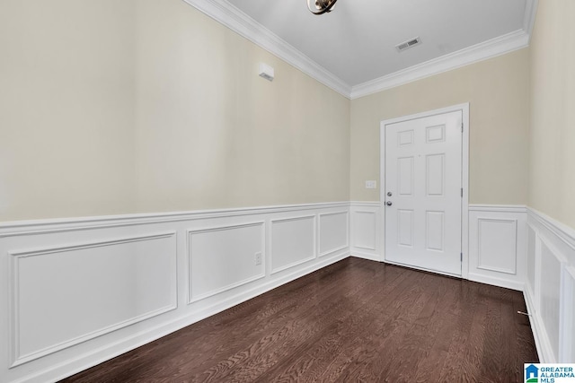 empty room with hardwood / wood-style flooring and ornamental molding