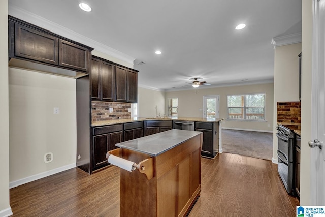 kitchen featuring kitchen peninsula, dark brown cabinets, black range with electric cooktop, and dark hardwood / wood-style floors