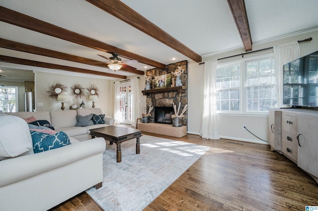 living room with a fireplace, hardwood / wood-style floors, and beamed ceiling