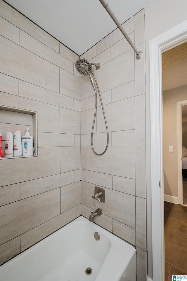 bathroom with tile patterned flooring and tiled shower / bath combo